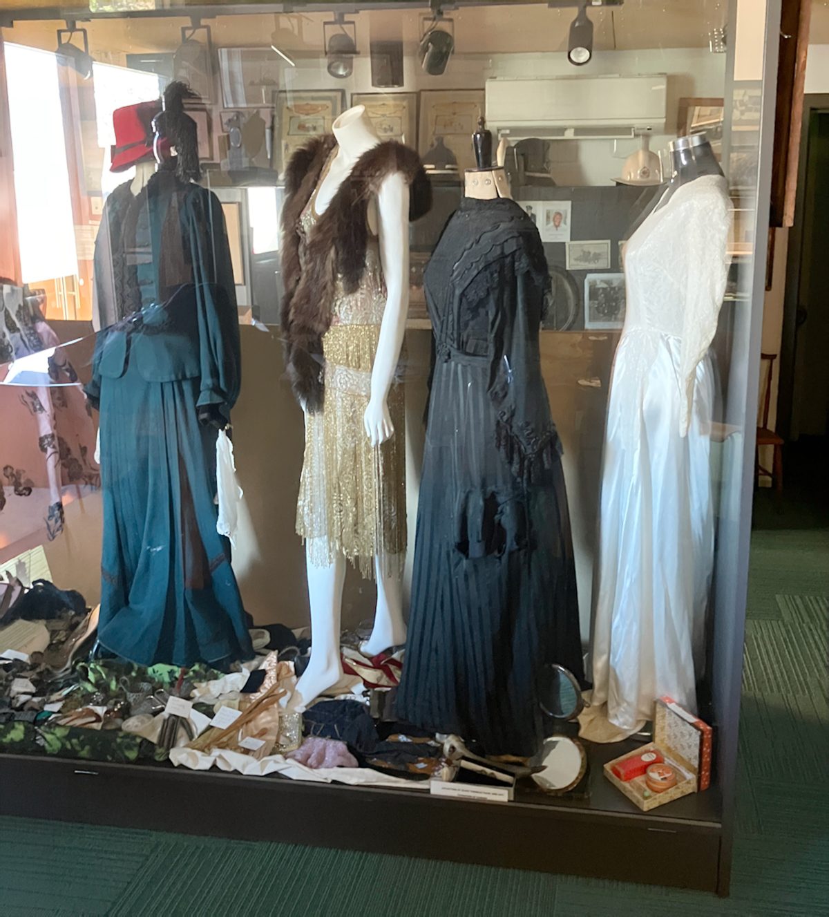 Display case of historical costume — Victorian and Edwardian dresses on mannequins