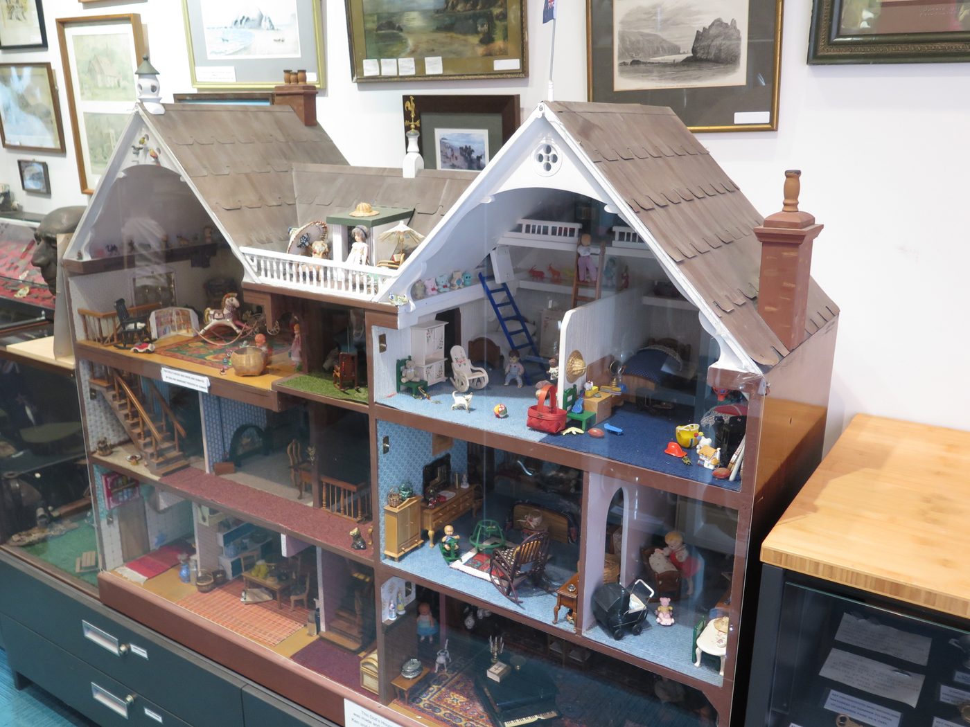 A large handmade dolls' house, open to show its furnished rooms